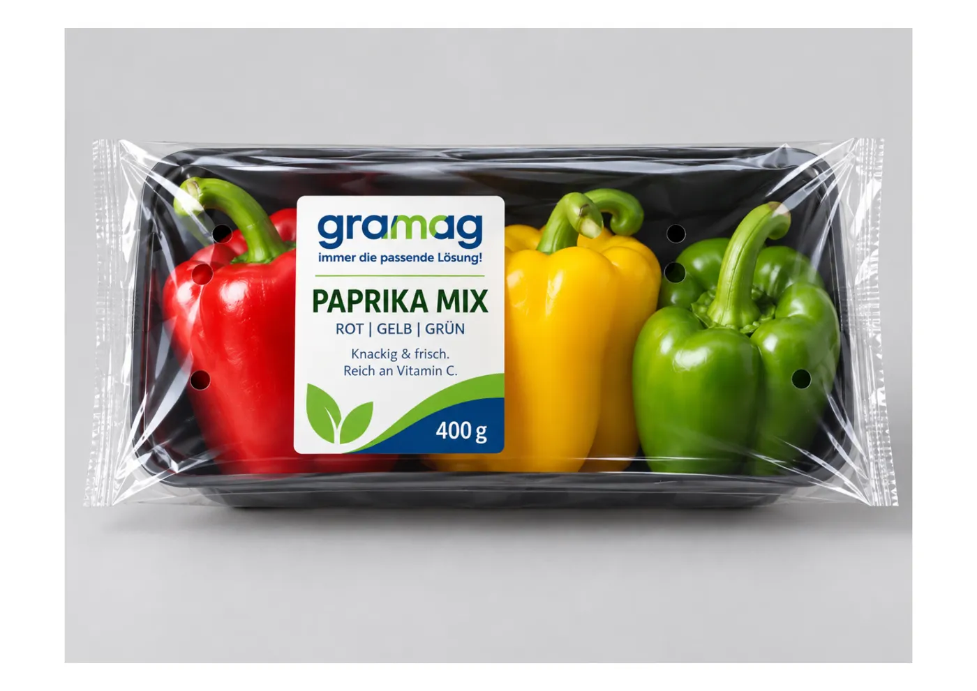 Paprika-Mix rot, gelb und grün in dunkler Schale mit transparenter, perforierter Folie